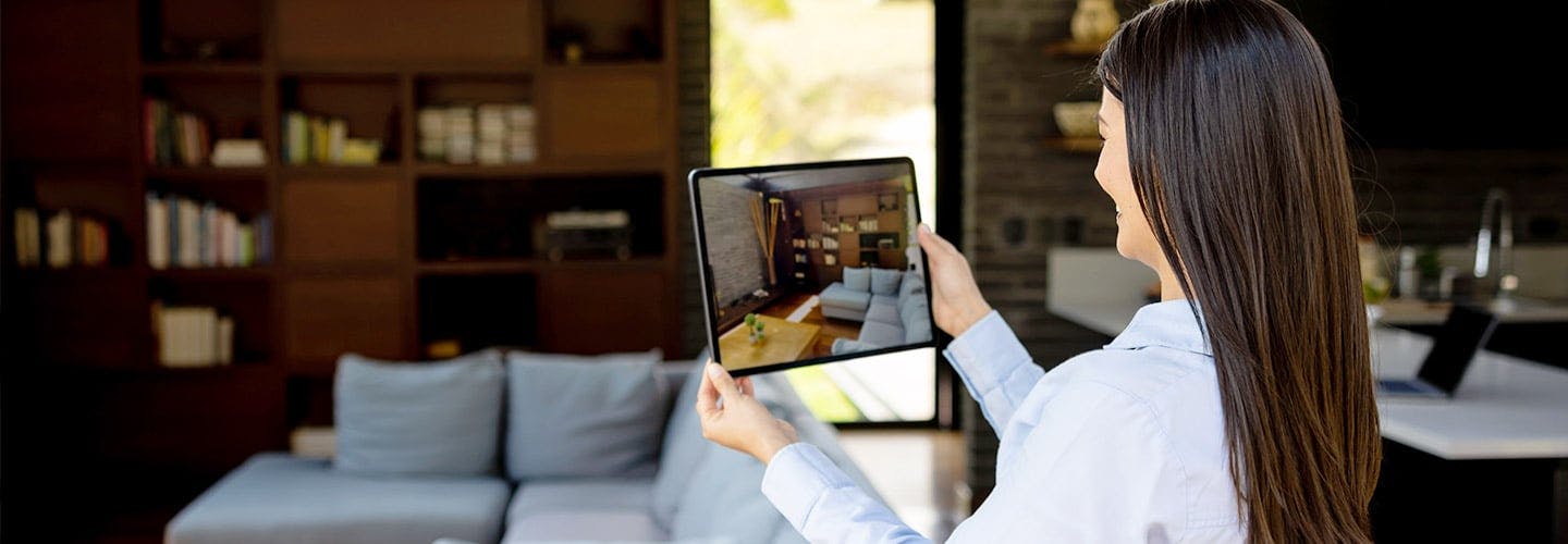 woman taking a picture of a living room on a tablet