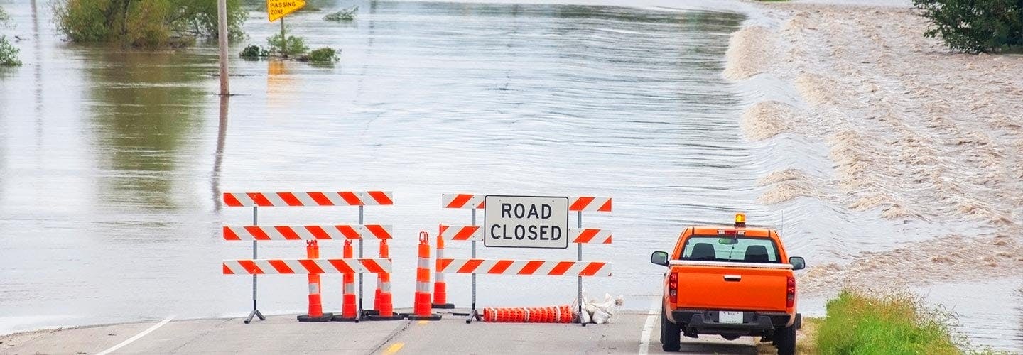 Road closed signs on a flooded road