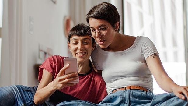 Two women looking at a cell phone