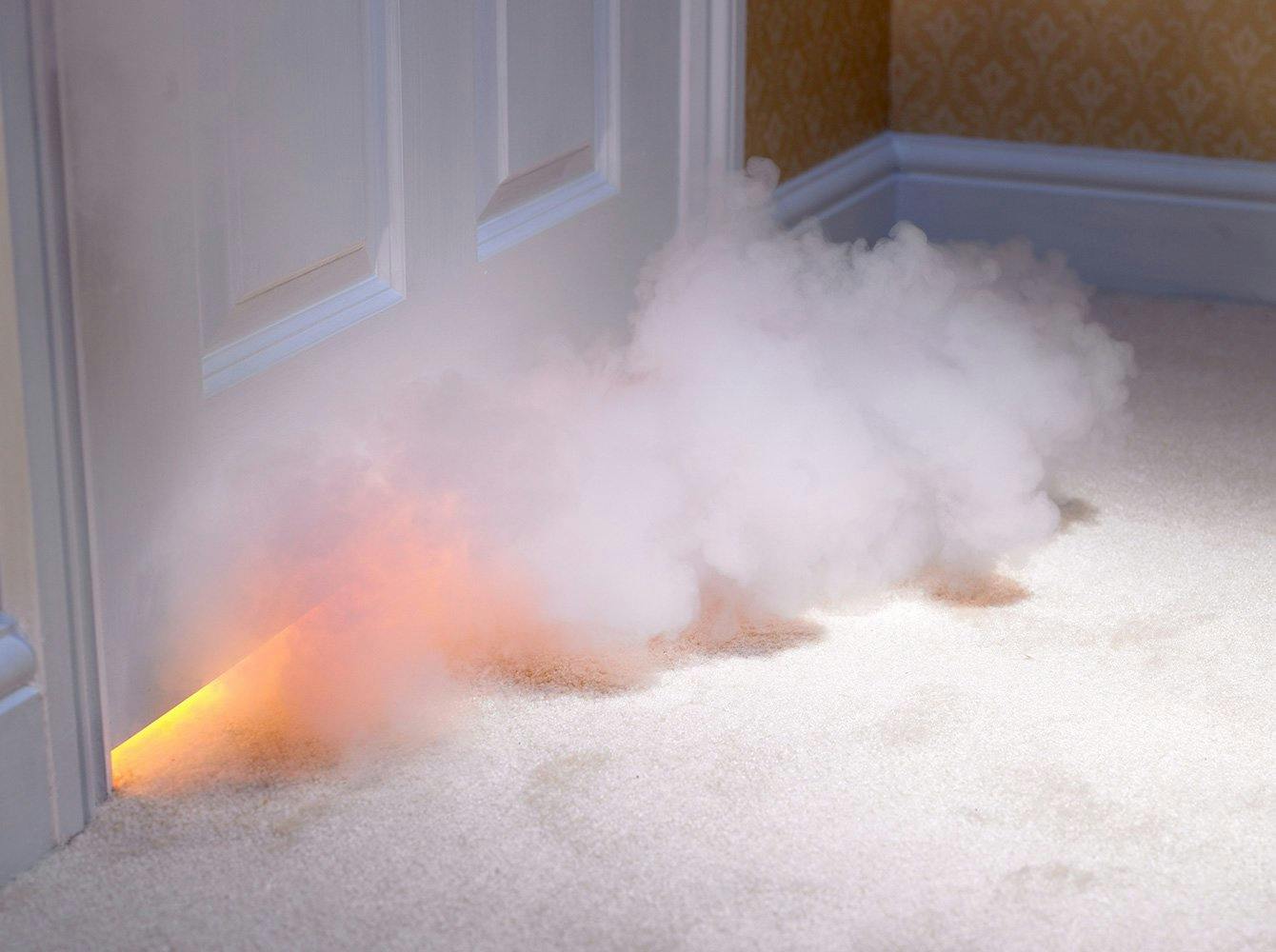 Smoke coming from under a closed door